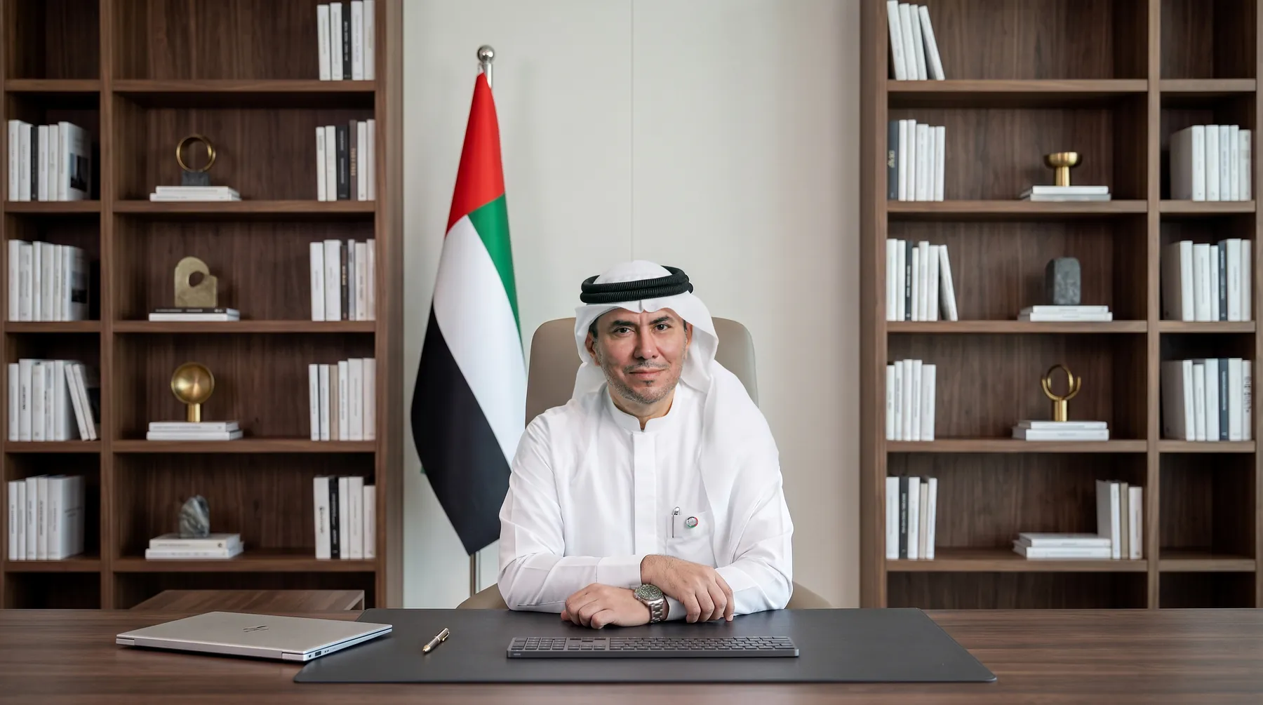H.E. Dr. Abdulrahmaan Al Ansaari at his desk
